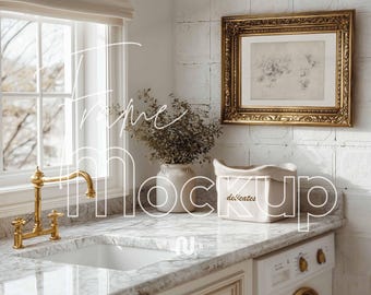 May include: A laundry room mockup with a gold-framed picture, a white sink with a gold tap, and a washing machine. The countertop is marble, and a white container with the word "delicates" is visible.