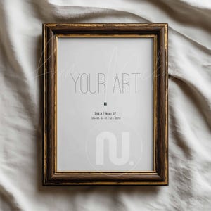 May include: A rectangular picture frame with a dark brown wood finish and gold trim. The frame holds a white print with the words "YOUR ART" in a minimalist font. The print size is 50 x 70cm, or approximately 19.7 x 27.6 inches.