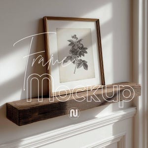 May include: A framed botanical print featuring a detailed black and white floral illustration. The frame is gold-toned, and the print is displayed on a rustic, weathered wooden shelf. The text "Frame Mockup" is overlaid on the image.