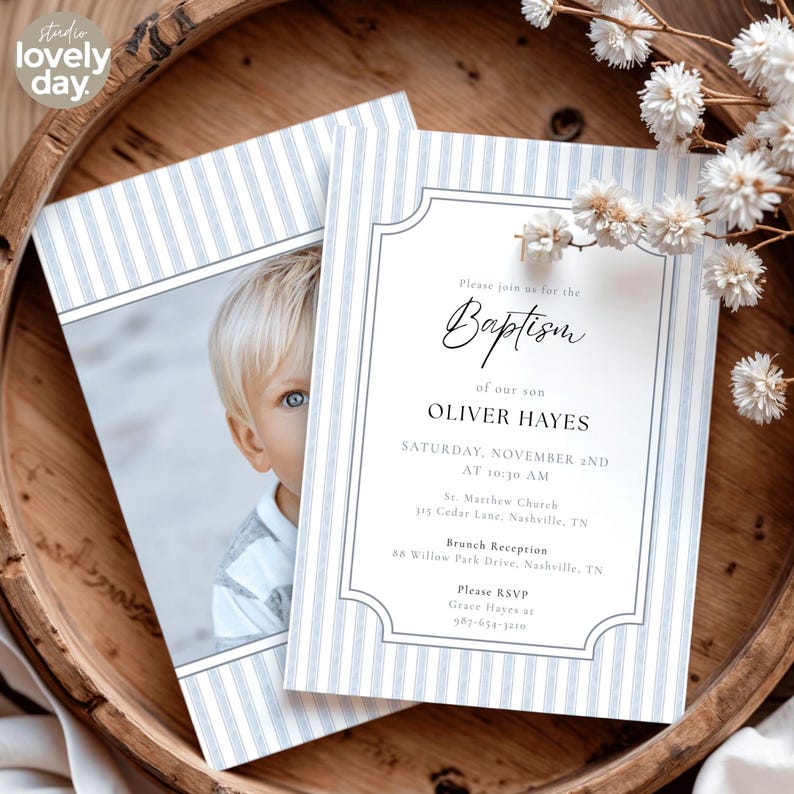 May include: Baptism invitation featuring a photo of a young boy. The invitation has a blue and white striped border and includes the text "Please join us for the Baptism of our son Oliver Hayes". The invitation is in a wooden bowl.