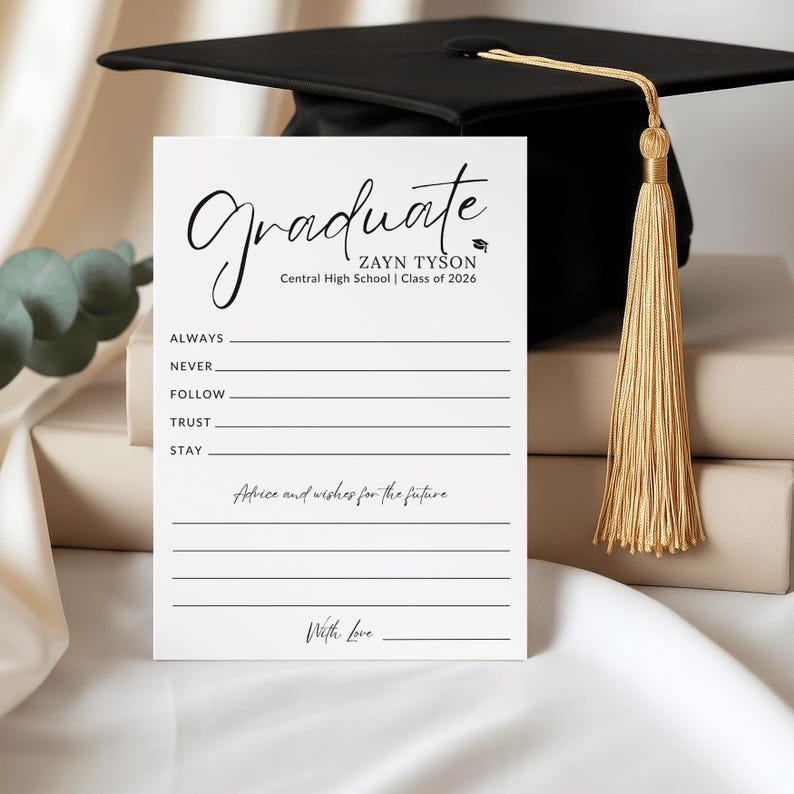 May include: A graduation card with the word "Graduate" in elegant script. The card includes space for advice and wishes, with a graduation cap and tassel in the background. The card is personalized with a name and class year.