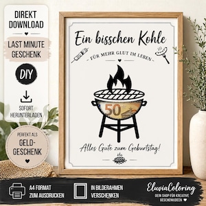 Könnte beinhalten: Ein gerahmter Druck mit einer schwarzen Grafik eines Grills mit Flammen und einem darin sichtbaren 50-Euro-Schein. Der Text lautet Ein bisschen Kohle, Für mehr Glut im Leben und Alles Gute zum Geburtstag, ergänzt durch kleine Illustrationen von einem Spieß, einer Wurst und einem Steak.