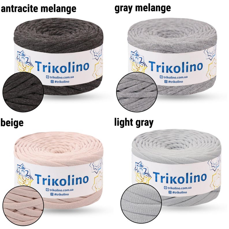 May include: Four spools of Trikolino yarn in various colors: anthracite melange, gray melange, beige, and light gray. Each spool has a label with the brand name and website address. The yarn is tightly wound, showing the texture of the material.