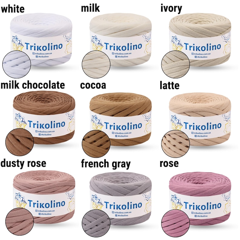 May include: A collection of Trikolino yarn in various colors, including white, milk, ivory, milk chocolate, cocoa, latte, dusty rose, French gray, and rose. Each skein is labeled with the Trikolino logo and color name. The yarn is displayed in a neat arrangement.