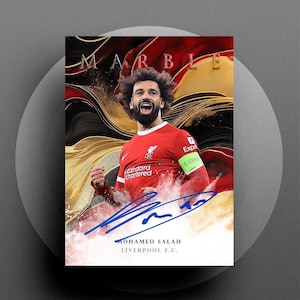 May include: A portrait of Mohamed Salah in a red Liverpool F.C. jersey with a signature. The background features a marble design with gold and red accents. The word "MARBLE" is at the top, and the text "MOHAMED SALAH LIVERPOOL F.C." is at the bottom.