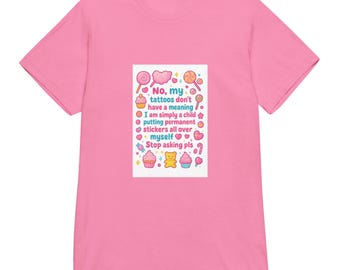 May include: Pink t-shirt with a rectangular graphic featuring the text "No, my tattoos don't have a meaning. I am simply a child putting permanent stickers all over myself. Stop asking pls." The graphic includes colorful illustrations of lollipops, cupcakes, and hearts.