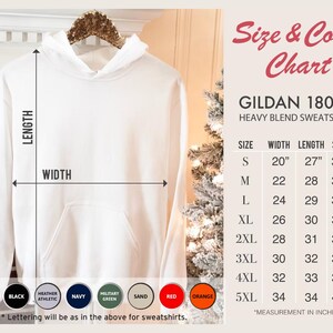 May include: A white hooded sweatshirt with a front pocket, hanging on a wooden hanger. The image includes a size and color chart with measurements in inches. Available colors include white, black, navy, and red.