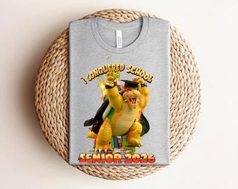 I Conquered School Senior 2026 T-shirt, Retro Bowser Trophy Graphic with Cap & Gown, Heather Mauve Gamer Fan Graduation Tee