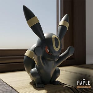 May include: A black and yellow figurine of a creature with long ears, red eyes, and a yellow oval marking on its forehead. The figure has a smooth finish and is posed in a seated position. The text MAPLE 3D PRINTING is visible in the corner.