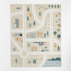 May include: A beige rug with a city map design. The rug features roads, buildings, trees, and a playground. Buildings are in shades of blue, yellow, and brown. The roads are white with black dashed lines. Trees are green and yellow.