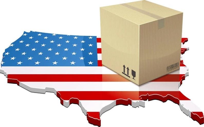 May include: A cardboard box with shipping symbols sits atop a 3D rendering of the United States map, which is colored with the American flag. The image suggests domestic shipping and e-commerce.