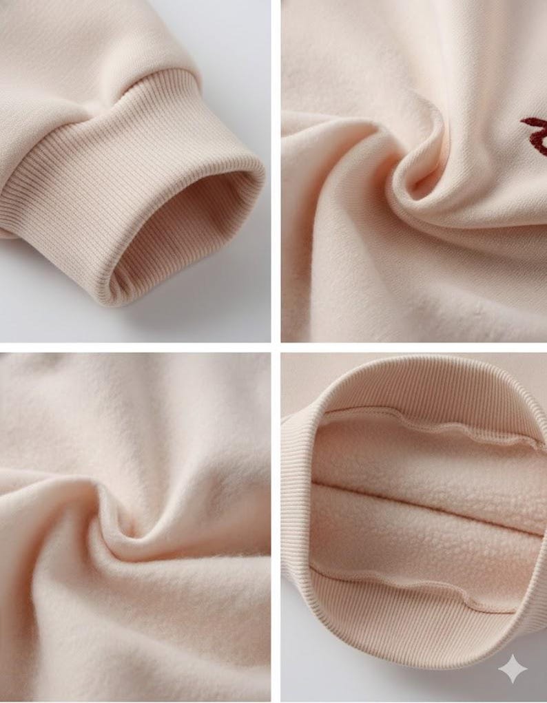 May include: Close-up shots of a beige sweatshirt, showcasing details like the ribbed cuffs and the soft, fleecy interior. The fabric appears thick and warm, suggesting a cozy garment. The color is a neutral, light beige.