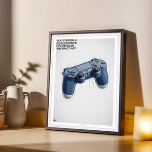 May include: Framed print featuring a blue PlayStation 4 DualShock controller in an abstract art style. The print includes the text "PLAYSTATION 4 DUALSHOCK CONTROLLER ABSTRACT ART" at the top. The controller is depicted with technical drawing lines.
