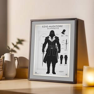 May include: Framed print featuring a black silhouette of Ezio Auditore from Assassin's Creed, with the text "EZIO AUDITORE SILHOUETTE" at the top. The artwork includes architectural details and weapon illustrations. The frame is dark gray.