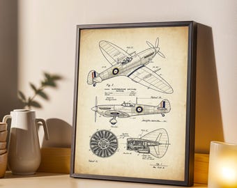 May include: Framed vintage-style print featuring detailed diagrams of a Supermarine Spitfire aircraft. The print showcases top, side, and component views in black ink on a tan background, with a black frame. A decorative piece for aviation enthusiasts.