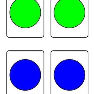 May include: Four flashcards with a white background and black borders. Two cards have a green circle, and two have a blue circle. The cards are likely for educational purposes.