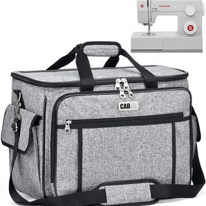 May include: A gray sewing machine bag with black accents and a matching gray sewing machine. The bag has multiple compartments, a shoulder strap, and a top handle. The sewing machine is a Singer brand.
