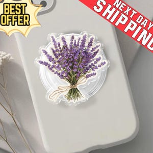 May include: A clear phone grip with a lavender bouquet tied with a beige ribbon. The grip is on a light grey phone case. The words "BEST OFFER" are in a yellow starburst. A red banner reads "NEXT DAY SHIPPING".