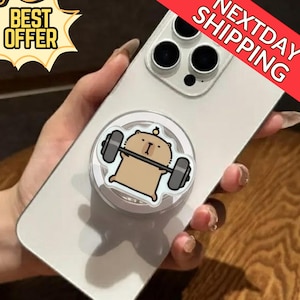 May include: A clear phone with a pop-up grip featuring a cartoon bear lifting weights. The grip is white with a brown bear design. The phone has a "Best Offer" and "Next Day Shipping" banner.