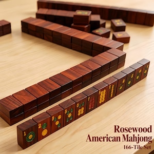 May include: A set of dark brown rosewood Mahjong tiles arranged in rows. The tiles feature engraved numbers and circular symbols in green, yellow, and red. The text Rosewood American Mahjong 166-Tile Set is printed in the bottom right corner.