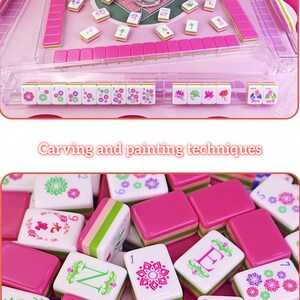 May include: A pink and white Mahjong set with tiles featuring floral and character designs. The set includes pink tile holders and a clear plastic case. The text "Carving and painting techniques" is visible.