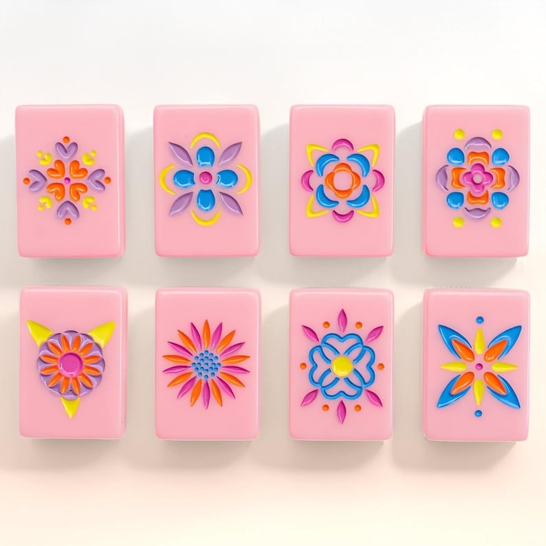 May include: Eight rectangular pink tiles arranged in two rows of four. Each tile features a unique, colorful, embossed floral or geometric pattern in shades of blue, yellow, orange, purple, and pink, creating a vibrant and symmetrical design.