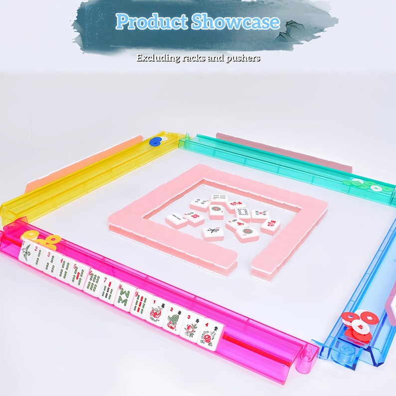 May include: A set of four translucent plastic mahjong racks in yellow, teal, pink, and blue, arranged in a square. The pink rack holds white mahjong tiles with various red, green, and black symbols. Additional tiles are scattered in the center.