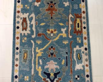 Blue Area Rug with Colorful Geometric Motifs
