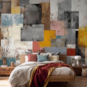 May include: A bedroom featuring a large wall mural with a grid of overlapping rectangular blocks in shades of gray, white, yellow, blue, and red. The bed has a beige duvet, a dark red throw blanket, and pillows in red, blue, and white.