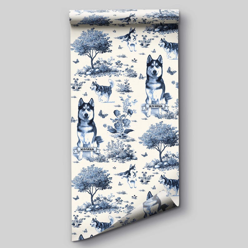 May include: A roll of wallpaper featuring a blue and white toile design. The pattern includes illustrations of Siberian huskies, trees, butterflies, and floral elements. The word "Maverick" is written on a banner below some of the dogs.