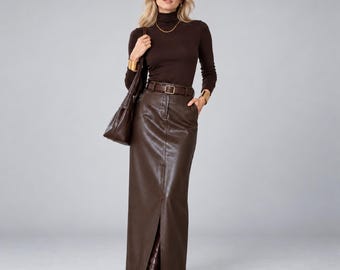 May include: A dark brown long-sleeve turtleneck sweater paired with a matching dark brown faux leather maxi skirt featuring a front slit, a belt with a rectangular buckle, and a dark brown shoulder bag with dark brown pointed-toe boots.