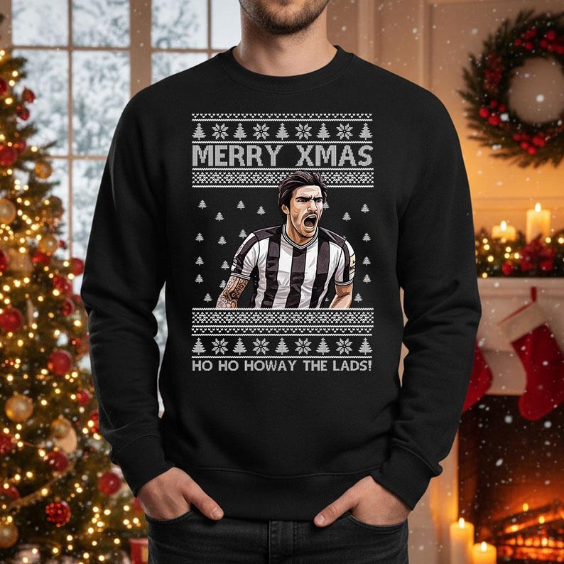 May include: Black sweatshirt with a festive design. The text "MERRY XMAS" is above a graphic of a soccer player in a black and white striped jersey. The text "HO HO HOWAY THE LADS!" is below the graphic.