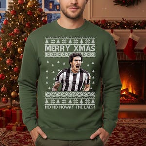 May include: Green Christmas sweater with the text "MERRY XMAS" and "HO HO HOWAY THE LADS!". The sweater features a graphic of a soccer player in a black and white striped jersey. The sweater has a festive design with snowflakes and Christmas trees.