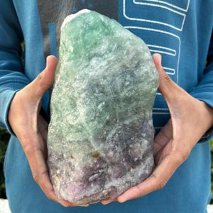 May include: A set of three ceramic mugs with a speckled, matte finish. The mugs are in shades of cream, light gray, and dark gray. Each mug has a simple, minimalist design, perfect for coffee or tea.