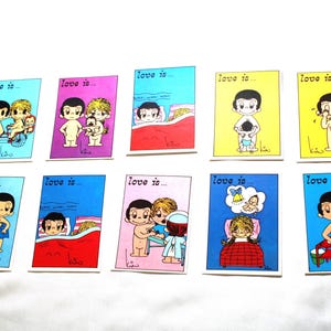 May include: A collection of ten rectangular cards featuring the Love is... cartoon characters in various colorful scenes. Each card displays the text Love is... at the top and a signature by Kim at the bottom, depicting illustrated figures in daily life situations.