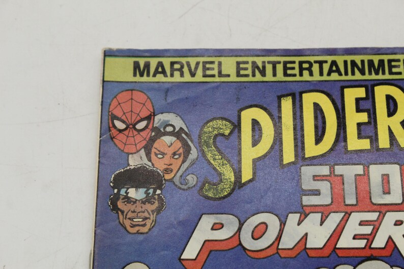 May include: Comic book cover featuring Spider-Man, Storm, and a third character. The title "Spider-Man" is in large yellow letters, with "Storm" and "Power" in red and white. The Marvel Entertainment logo is at the top.