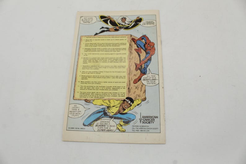 May include: Comic book page featuring Marvel superheroes Spider-Man, Storm, and Luke Cage. The page includes text about the American Cancer Society and the dangers of smoking. The comic is on a white background.