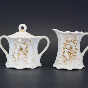 Vintage Small Bisque Cream & Sugar Set with Carved Cherubs (E6920)