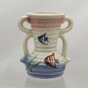 May include: A small white ceramic vase with two handles and a blue and white striped design. The vase is decorated with two fish, one blue and black and the other red and yellow.