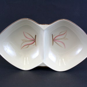 May include: A white ceramic divided serving dish with a brown rim and a pink and brown floral design.