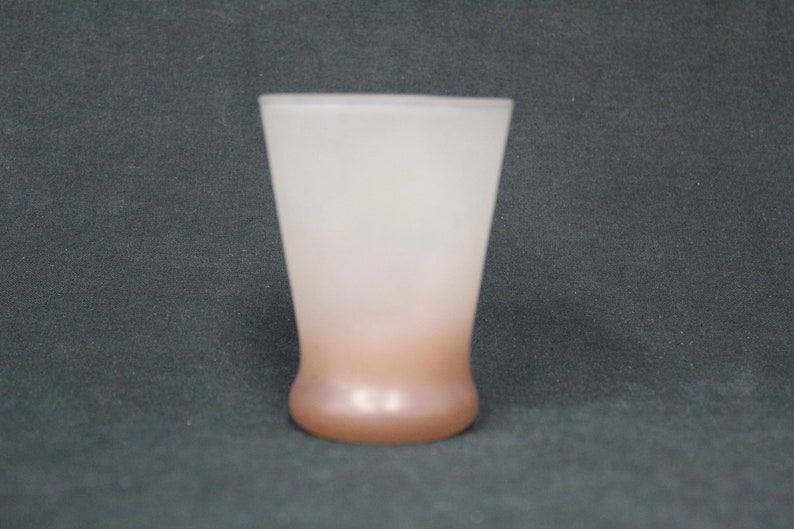 May include: A frosted glass tumbler with a brown ombre effect at the bottom. The glass is clear at the top and gradually transitions to a darker brown colour at the base.