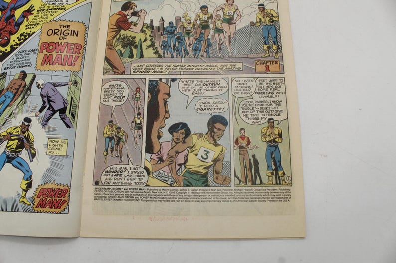 May include: Comic book page featuring panels from "Spider-Man" and "Power Man." The panels depict action scenes with characters in colorful costumes, including Spider-Man and Power Man. Text bubbles and captions add to the narrative.