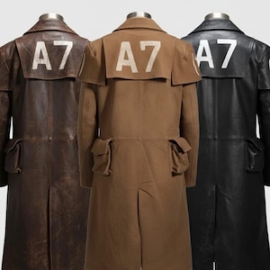 May include: Three long coats in brown, tan, and black, each with the white text "A7" on the back. The coats have a classic trench coat design with pockets and a back vent. The brown coat appears to be made of a canvas material, while the black and brown coats appear to be leather.