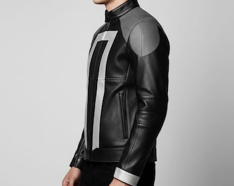 May include: Black leather jacket with gray shoulder accents and a vertical silver stripe design. The jacket features a stand-up collar, silver cuffs, and a front zipper. The jacket is worn by a person.