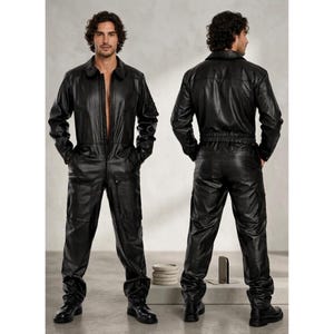 May include: A black leather jumpsuit with a collared neckline, long sleeves, and a front zipper closure. The jumpsuit features multiple pockets and is worn with black boots. The image shows both the front and back of the jumpsuit.