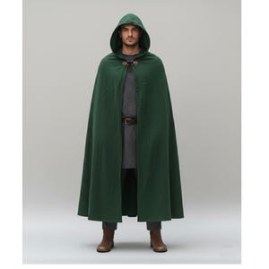 May include: A dark green hooded cloak with a leather clasp closure. The cloak is long and flowing, with a deep hood. The person is wearing a gray tunic and brown belt. The boots are brown.