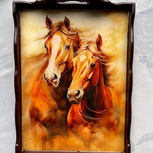 May include: A rectangular serving tray with a brown wooden frame. The tray features a painting of two horses with brown and white coats, set against a warm, golden background. The horses' manes and tails flow, creating a sense of movement.