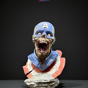May include: A detailed bust of a zombie Captain America, with a blue helmet bearing a white "A", a tattered blue and red collar, and a decaying face with an open mouth. The bust is set against a dark background, with the "X-Art Studio" logo visible.