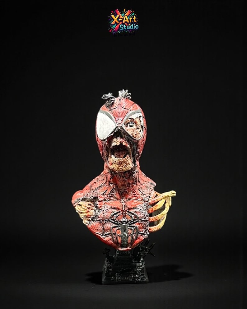 May include: A detailed bust of a zombie Spider-Man, featuring a red and black costume with exposed bone and decaying flesh. The bust is mounted on a black base, with the X-Art Studio logo in the top corner.
