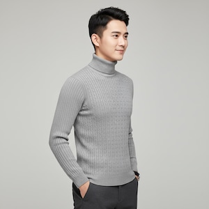 May include: A light gray turtleneck sweater with a cable knit design. The long-sleeved sweater has a ribbed texture on the sleeves and a classic, comfortable fit. The sweater is made of a soft, warm material.